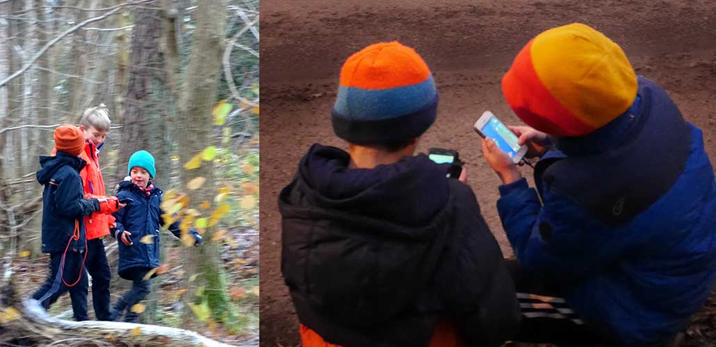 Barn som går runt utomhus med höjda mobiltelefoner. 